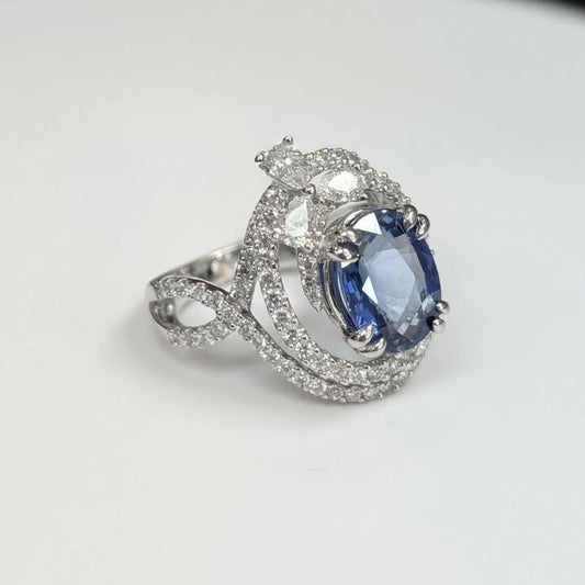 3.75 CT Oval-cut Blue Sapphire with 1.47 CT.T.W Diamond Double Swirl Frame & Three-stone Pear-cut Accent with Double Claw Prongs in 18k White Gold