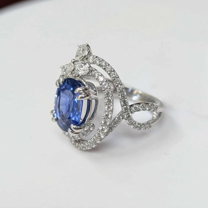 3.75 CT Oval-cut Blue Sapphire with 1.47 CT.T.W Diamond Double Swirl Frame & Three-stone Pear-cut Accent with Double Claw Prongs in 18k White Gold