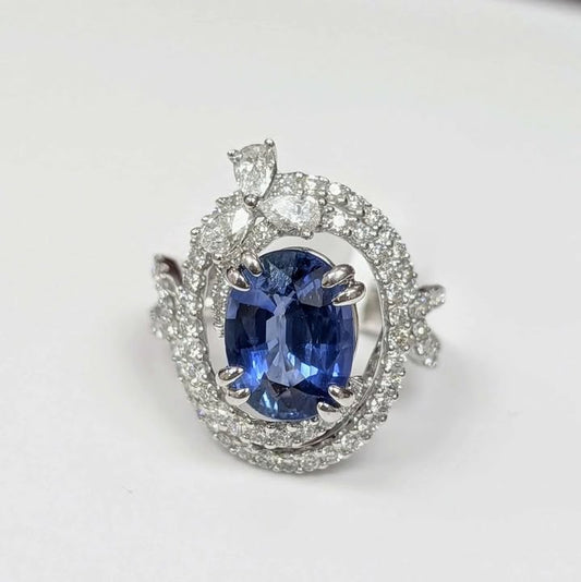3.75 CT Oval-cut Blue Sapphire with 1.47 CT.T.W Diamond Double Swirl Frame & Three-stone Pear-cut Accent with Double Claw Prongs in 18k White Gold