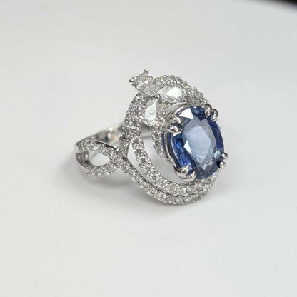 3.75 CT Oval-cut Blue Sapphire with 1.47 CT.T.W Diamond Double Swirl Frame & Three-stone Pear-cut Accent with Double Claw Prongs in 18k White Gold